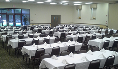 Rectangular tables ready for a business social event.